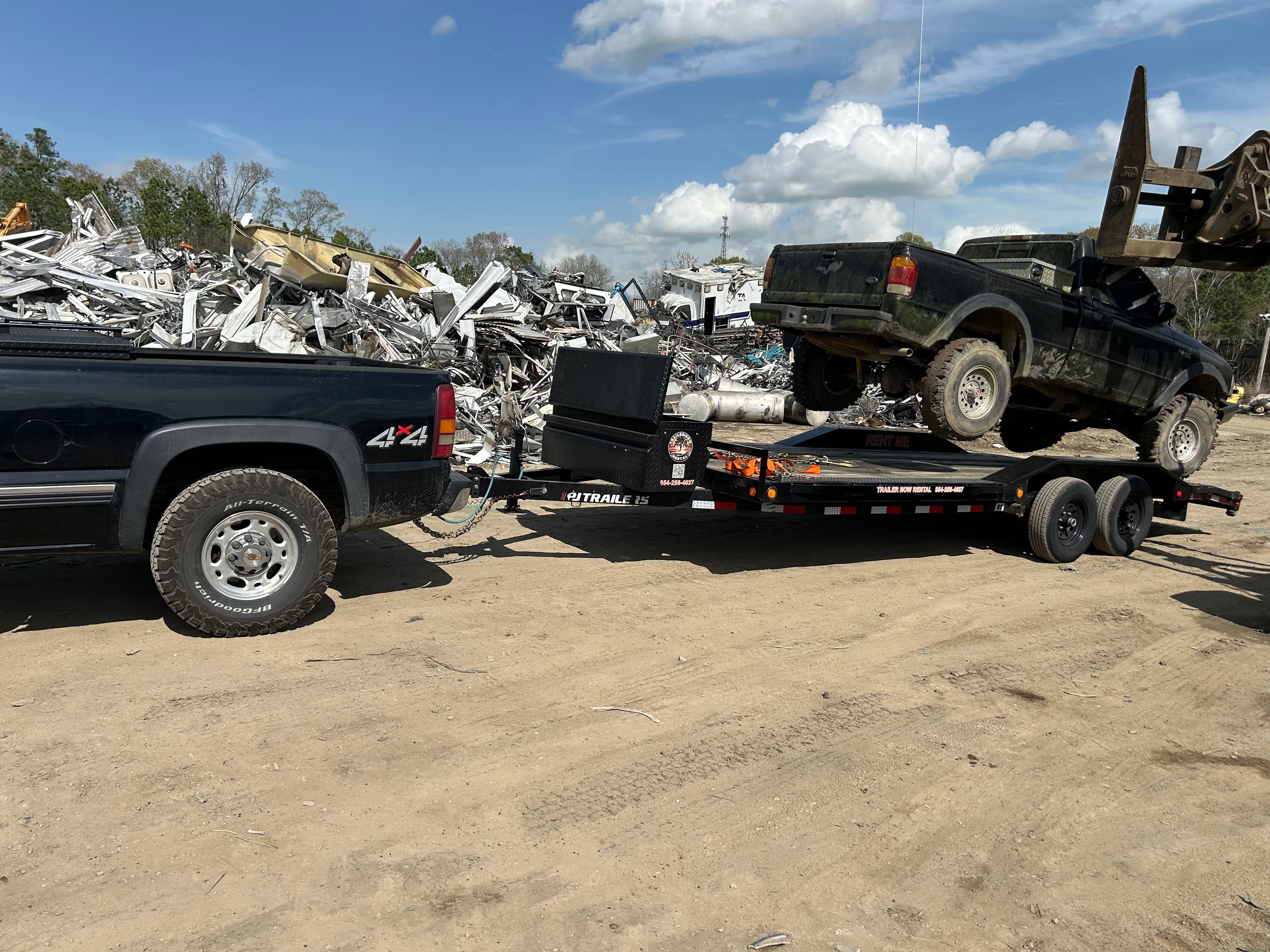Vintage truck on car hauler at scrapyard